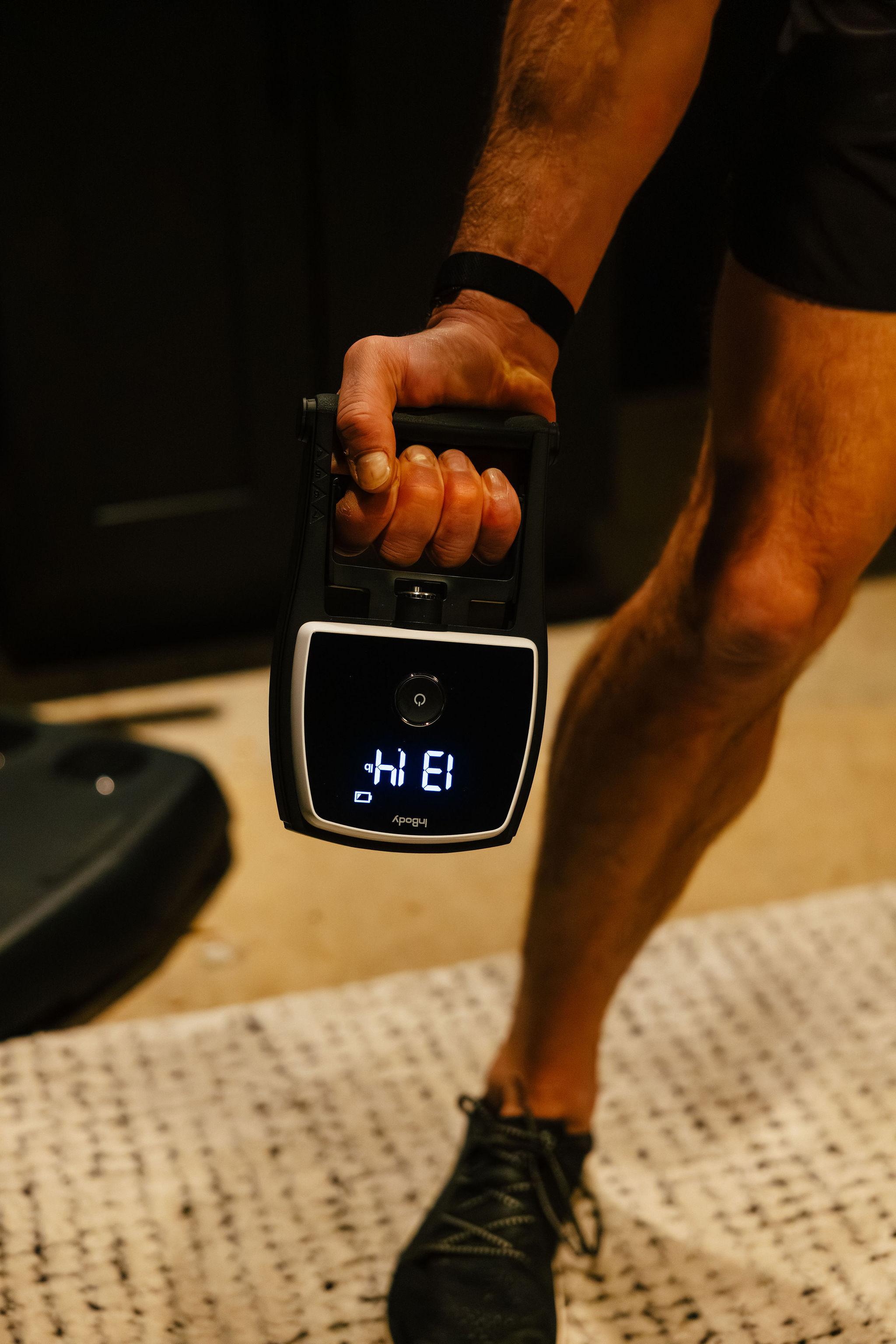 Patient gripping a hand dynamometer for the functional strength test.