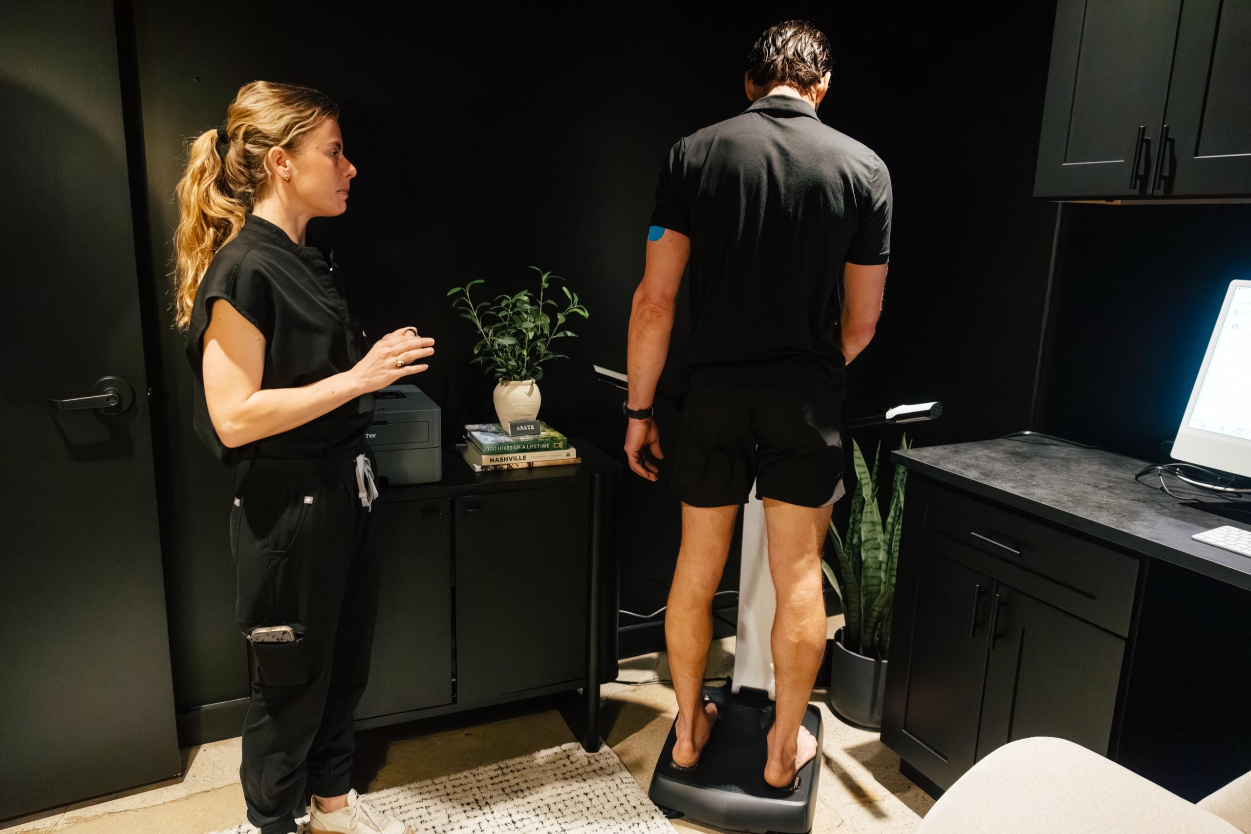Patient stepping onto the InBody body composition scanner.