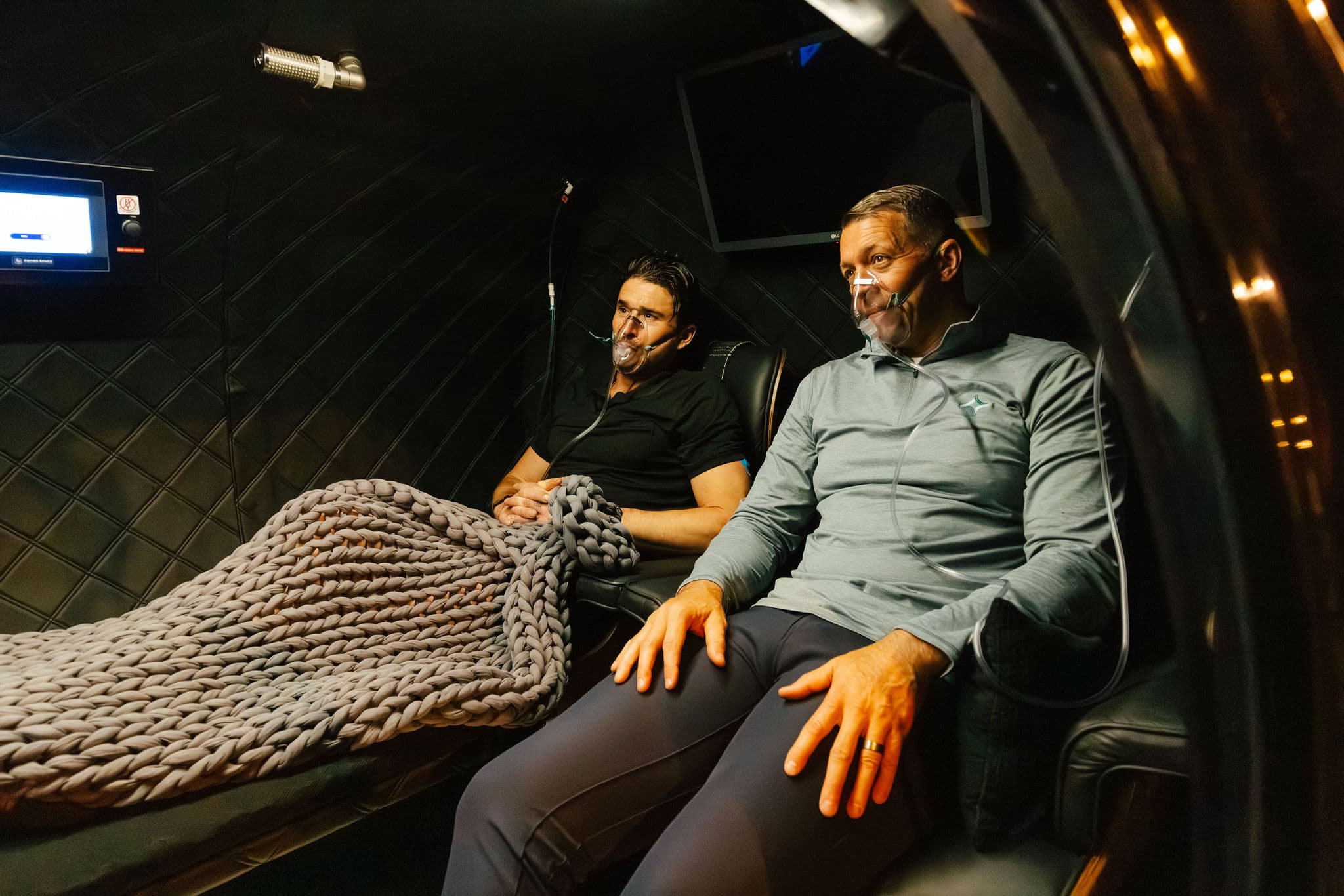 Two men relaxing in recovery chairs at Arete, an Agentis partner clinic